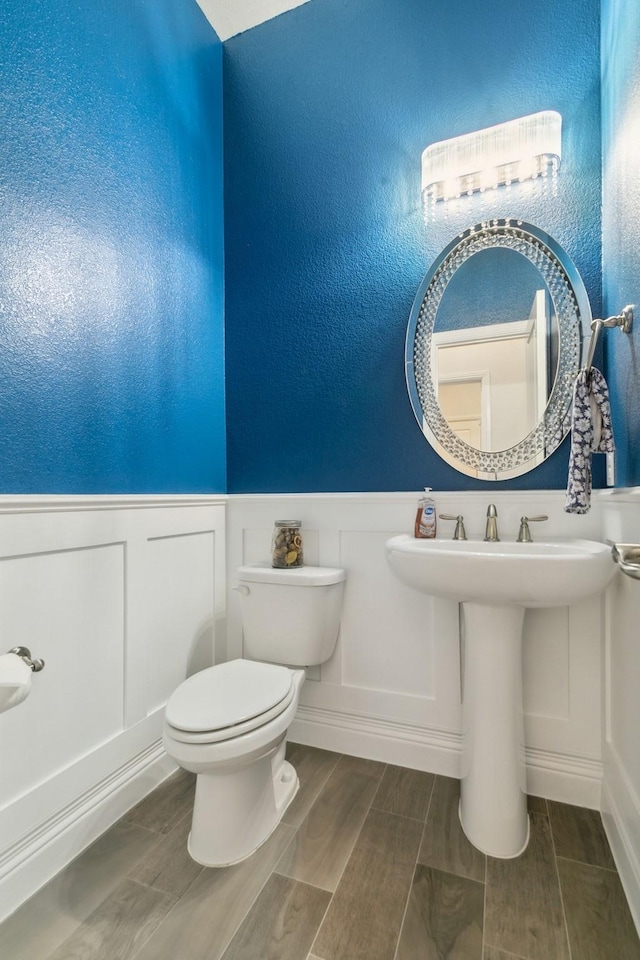 15236 Holly Bay Ct, Aledo, TX 76008 - bathroom featuring a decorative wall, a wainscoted wall, and wood finished floors