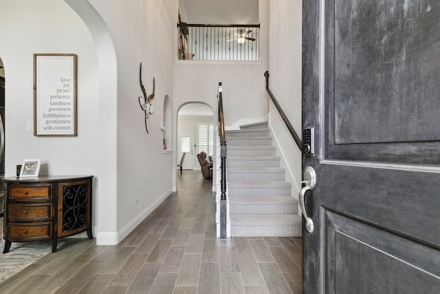 15236 Holly Bay Ct, Aledo, TX 76008 - entryway featuring arched walkways, stairs, wood finished floors, and a towering ceiling
