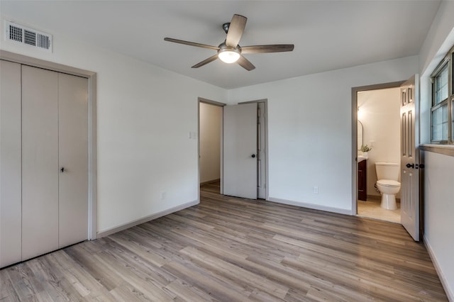 2000 Bettibart St, Fort Worth, TX 76134 - unfurnished bedroom featuring wood finished floors, ensuite bathroom, and a ceiling fan