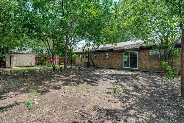 2000 Bettibart St, Fort Worth, TX 76134 - rear view of house with a storage unit and brick siding