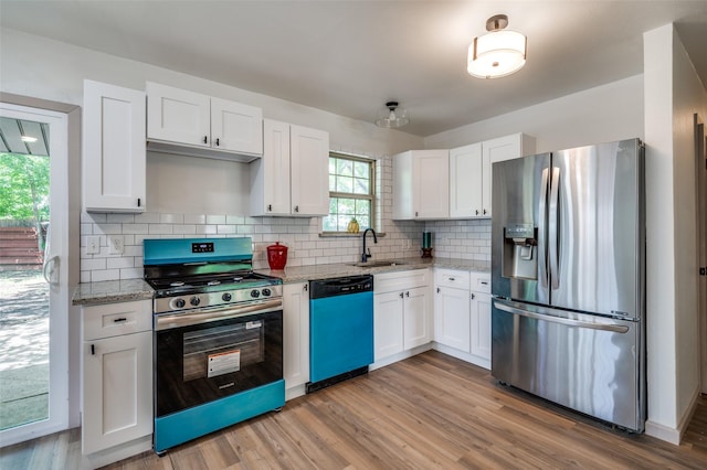 2000 Bettibart St, Fort Worth, TX 76134 - kitchen with stainless steel appliances, white cabinetry, light stone counters, and tasteful backsplash