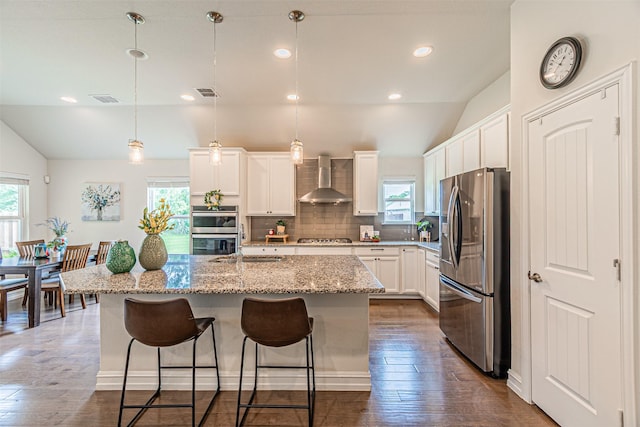 2923 Ash Ave, Melissa, TX 75454 - kitchen with stainless steel appliances, wall chimney range hood, healthy amount of natural light, vaulted ceiling, and a sink
