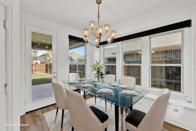 8141 Meadow Valley Dr, Mckinney, TX 75071 - dining room with a chandelier and wood finished floors