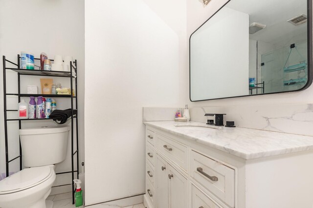 2517 Blanton St, Dallas, TX 75227 - full bathroom with vanity, toilet, a shower with door, and marble look tile flooring