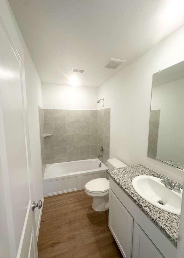 1408 Silver Oak Ln, Fort Worth, TX 76140 - full bathroom featuring vanity, wood finished floors, shower / tub combination, and toilet