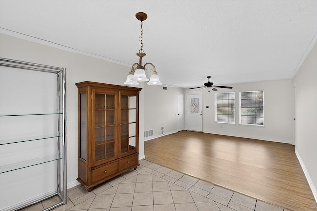 902 Church St, Sanger, TX 76266 - unfurnished room with light tile patterned flooring, ceiling fan, a chandelier, and crown molding