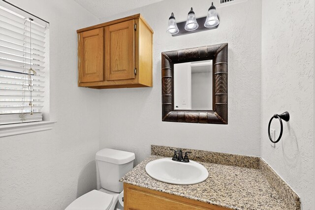 902 Church St, Sanger, TX 76266 - half bath with vanity and a textured wall