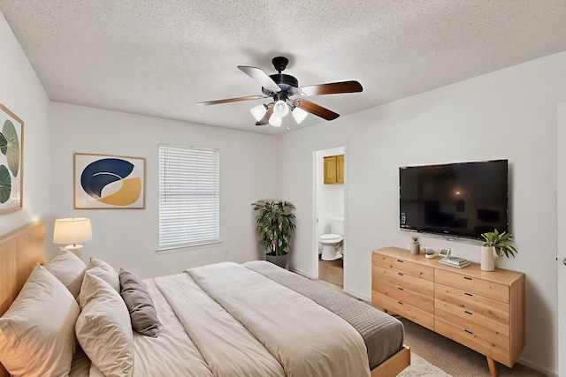 902 Church St, Sanger, TX 76266 - carpeted bedroom featuring connected bathroom, a textured ceiling, and a ceiling fan