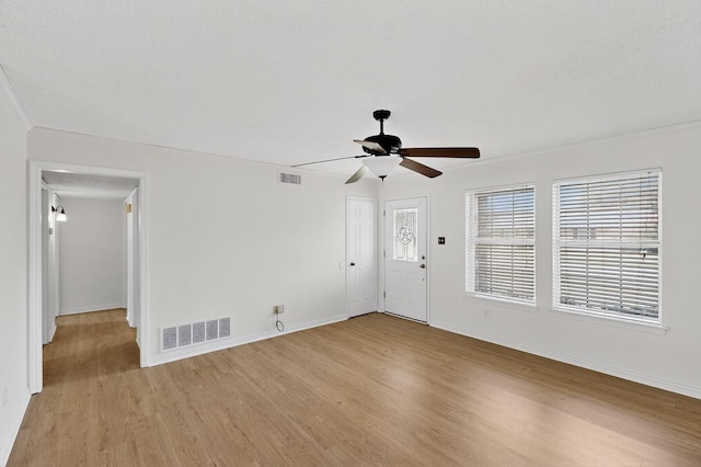 902 Church St, Sanger, TX 76266 - unfurnished living room featuring light wood-style flooring, a ceiling fan, and ornamental molding