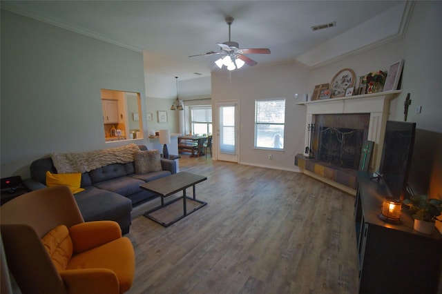 618 Matador Dr, Oak Point, TX 75068 - living room with wood finished floors, a ceiling fan, crown molding, a tile fireplace, and lofted ceiling