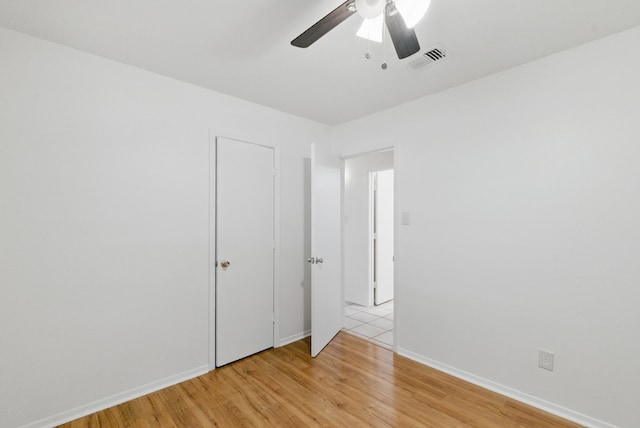805 S Rusk St, Weatherford, TX 76086 - empty room with light wood-type flooring, ceiling fan, and baseboards