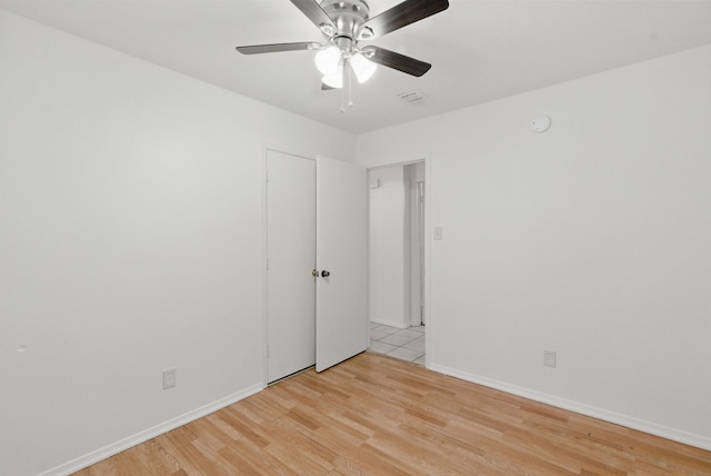 805 S Rusk St, Weatherford, TX 76086 - spare room with light wood-type flooring, a ceiling fan, and baseboards