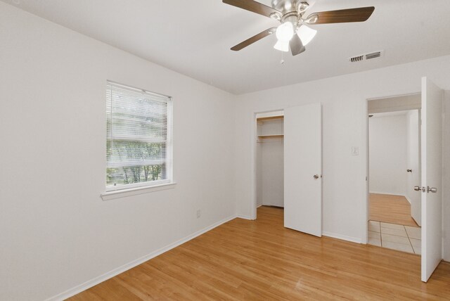 805 S Rusk St, Weatherford, TX 76086 - unfurnished bedroom with light wood-style flooring, baseboards, a closet, and a ceiling fan