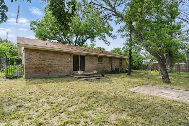 805 S Rusk St, Weatherford, TX 76086 - back of property featuring brick siding and central AC unit