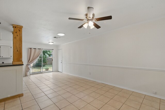 805 S Rusk St, Weatherford, TX 76086 - unfurnished room featuring a ceiling fan, light tile patterned floors, baseboards, and ornamental molding