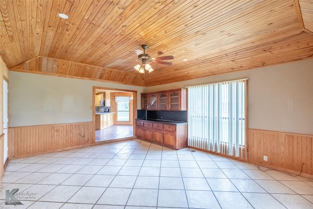 3017 County Road 154, Tuscola, TX 79562 - empty room with wood ceiling, wainscoting, wood walls, light tile patterned flooring, and a ceiling fan