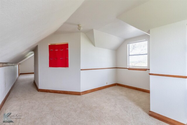 3017 County Road 154, Tuscola, TX 79562 - bonus room featuring carpet floors, vaulted ceiling, and baseboards