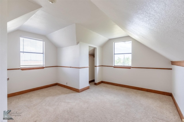 3017 County Road 154, Tuscola, TX 79562 - additional living space with light carpet, plenty of natural light, vaulted ceiling, and baseboards