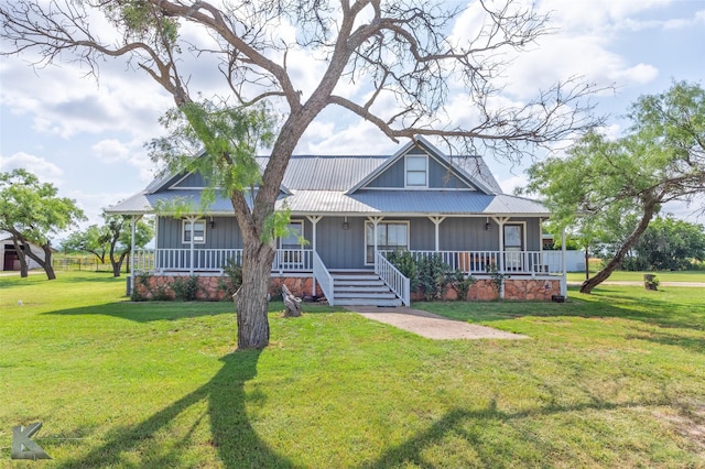 3017 County Road 154, Tuscola, TX 79562 - farmhouse-style home with a porch, metal roof, board and batten siding, and a front yard