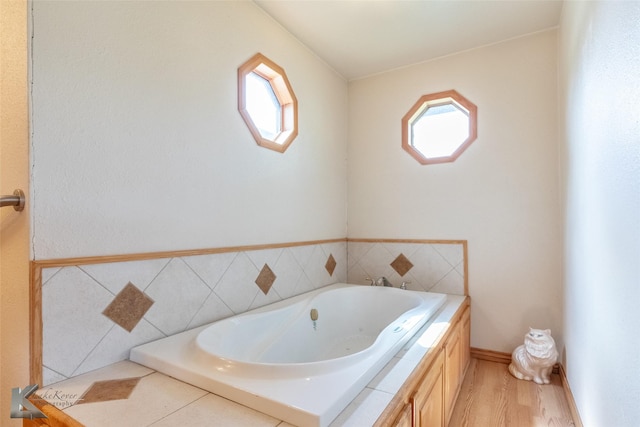 3017 County Road 154, Tuscola, TX 79562 - full bathroom featuring a bath and wood finished floors