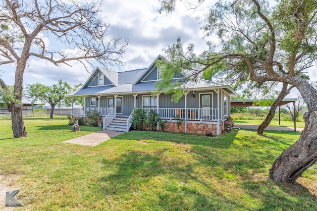 3017 County Road 154, Tuscola, TX 79562 - farmhouse with board and batten siding, covered porch, and a front yard