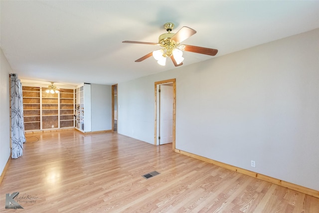 3017 County Road 154, Tuscola, TX 79562 - spare room featuring ceiling fan, built in shelves, wood finished floors, and baseboards