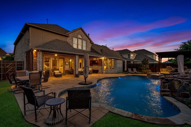 7363 Calla Lilly Ln, Frisco, TX 75034 - pool at dusk featuring a fenced backyard, a patio area, and a pool with connected hot tub