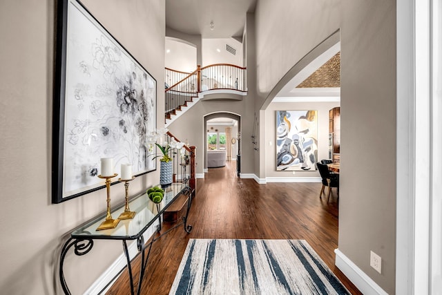 7363 Calla Lilly Ln, Frisco, TX 75034 - foyer entrance with arched walkways, wood finished floors, baseboards, a towering ceiling, and stairway