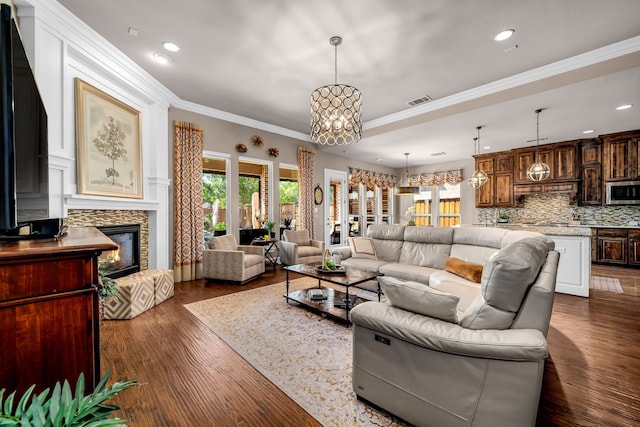 7363 Calla Lilly Ln, Frisco, TX 75034 - living area featuring plenty of natural light, a chandelier, a fireplace, dark wood-style flooring, and ornamental molding