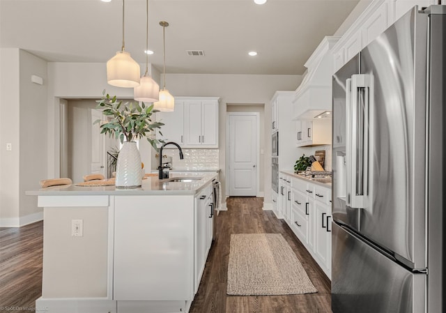 752 Fletcher Dr, Fate, TX 75087 - kitchen with appliances with stainless steel finishes, a sink, a kitchen island with sink, dark wood-style floors, and white cabinetry
