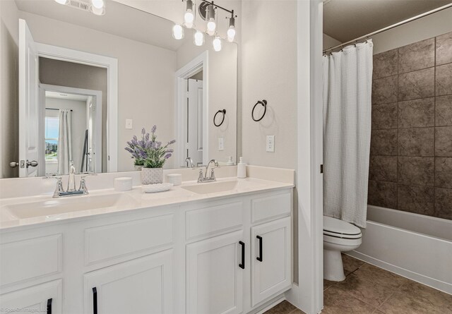 752 Fletcher Dr, Fate, TX 75087 - bathroom featuring double vanity, toilet, tile patterned floors, and shower / bathtub combination with curtain