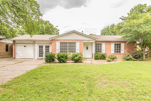 133 SE Newton Dr, Burleson, TX 76028 - ranch-style home featuring a garage, brick siding, driveway, a front yard, and french doors