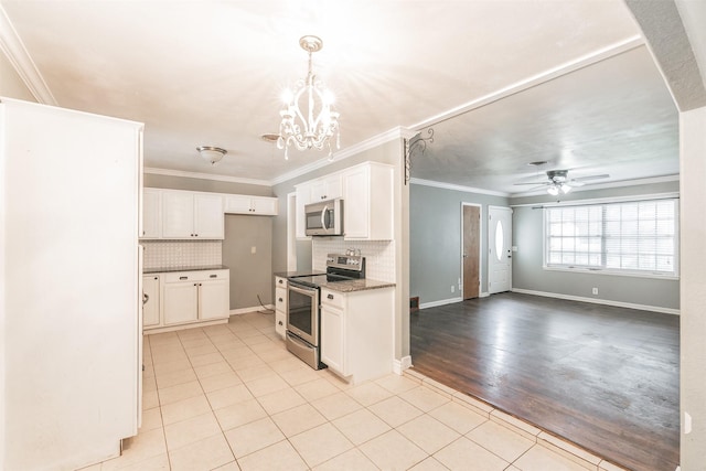 133 SE Newton Dr, Burleson, TX 76028 - kitchen featuring appliances with stainless steel finishes, light tile patterned floors, a chandelier, backsplash, and ornamental molding