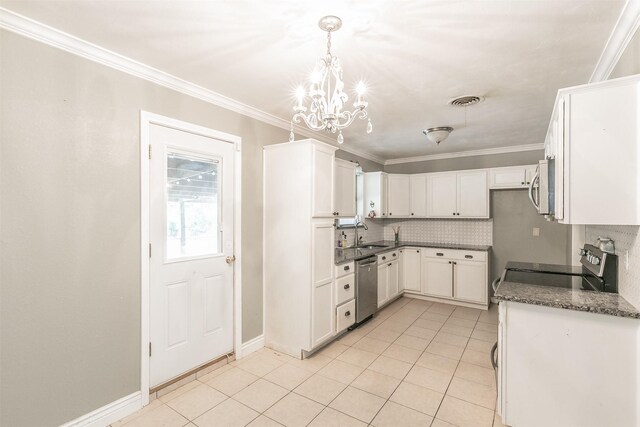133 SE Newton Dr, Burleson, TX 76028 - kitchen featuring stainless steel appliances, a chandelier, light tile patterned floors, decorative backsplash, and ornamental molding