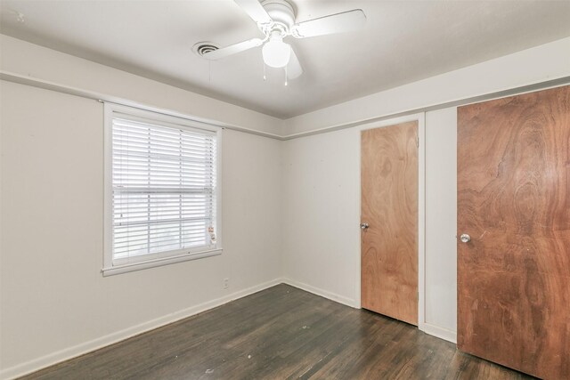133 SE Newton Dr, Burleson, TX 76028 - unfurnished bedroom with wood finished floors, baseboards, and a ceiling fan