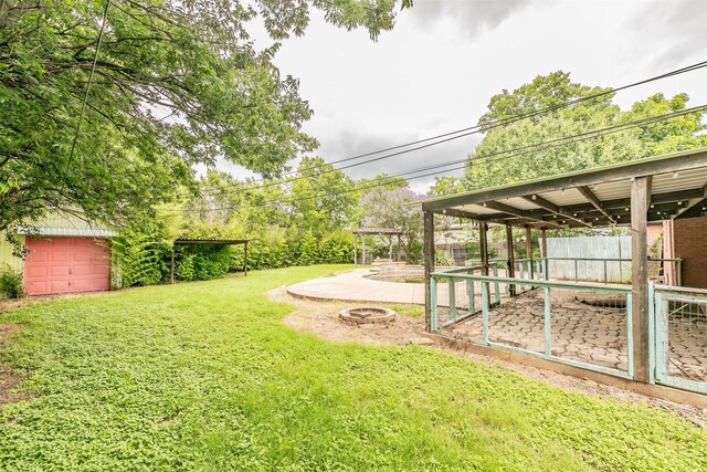 133 SE Newton Dr, Burleson, TX 76028 - view of green lawn with an outbuilding, exterior structure, and an outdoor fire pit