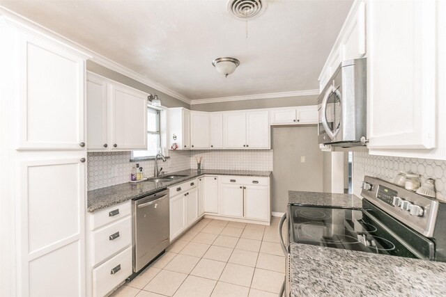 133 SE Newton Dr, Burleson, TX 76028 - kitchen with stainless steel appliances, a sink, light tile patterned floors, tasteful backsplash, and white cabinets
