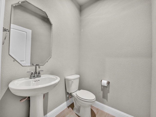 9100 Cacti Ct, Fort Worth, TX 76036 - bathroom featuring toilet, wood finished floors, and baseboards