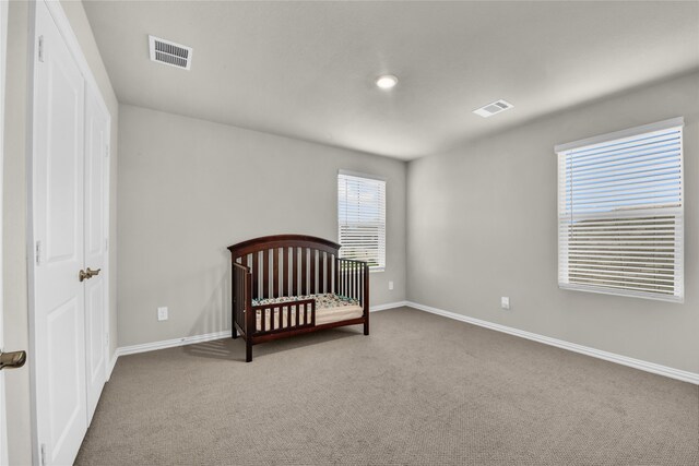9100 Cacti Ct, Fort Worth, TX 76036 - carpeted bedroom featuring baseboards and a crib