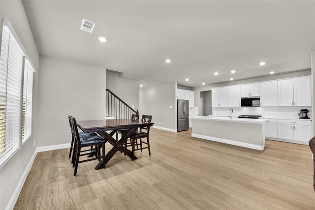 9100 Cacti Ct, Fort Worth, TX 76036 - dining space featuring light wood-style floors, baseboards, recessed lighting, and stairway
