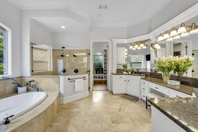7209 Braemar Ter, Colleyville, TX 76034 - bathroom featuring healthy amount of natural light, a walk in shower, a garden tub, vanity, and crown molding