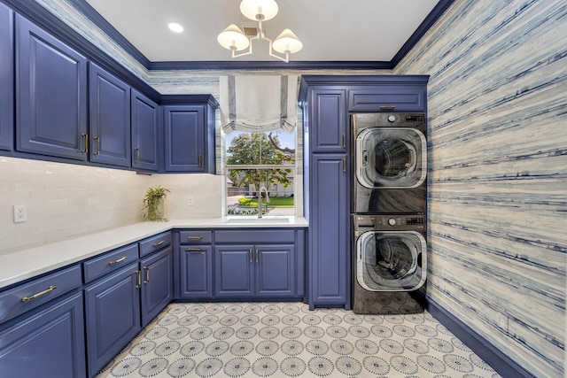 7209 Braemar Ter, Colleyville, TX 76034 - washroom with stacked washer and clothes dryer, wood walls, crown molding, a chandelier, and cabinet space