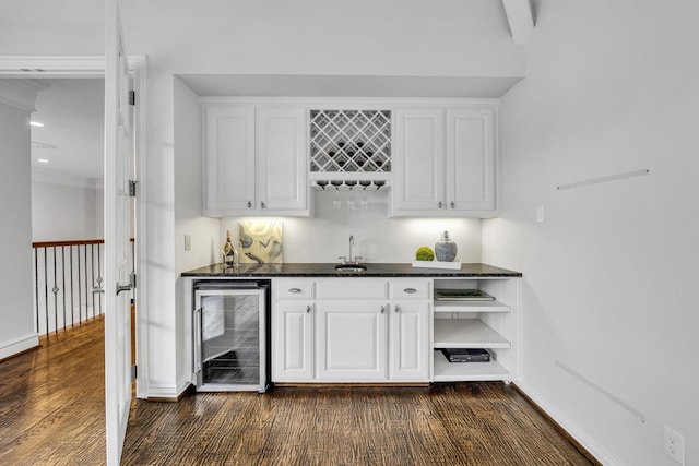 7209 Braemar Ter, Colleyville, TX 76034 - indoor wet bar featuring wine cooler, baseboards, and dark wood-style flooring