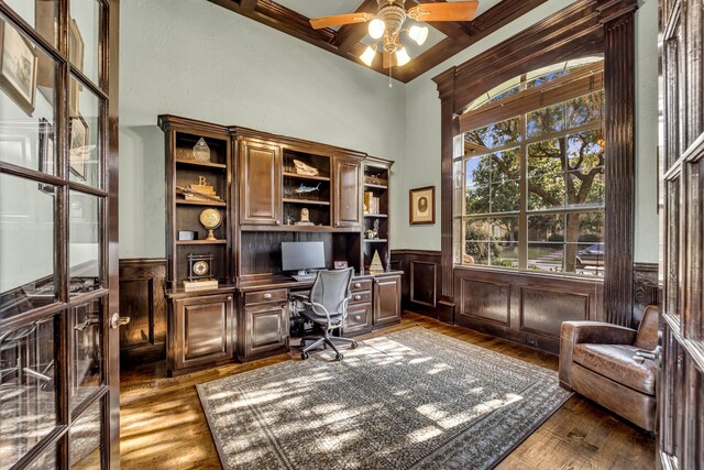 7209 Braemar Ter, Colleyville, TX 76034 - office with wood finished floors, a ceiling fan, wainscoting, built in desk, and a towering ceiling