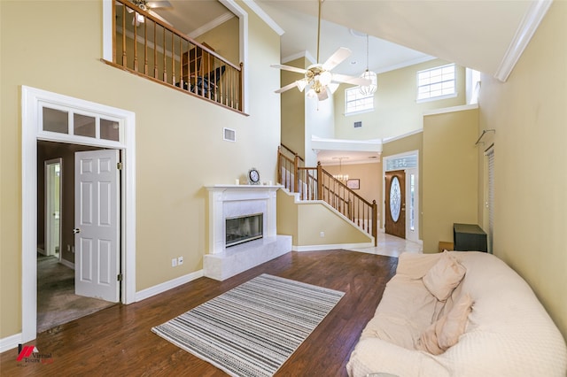3635 Greenacres Place Dr Unit 350, Bossier City, LA 71111 - living room with stairway, a ceiling fan, wood finished floors, ornamental molding, and a towering ceiling