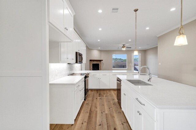 5128 Country Club Dr, Granbury, TX 76049 - kitchen with appliances with stainless steel finishes, a sink, ceiling fan, tasteful backsplash, and light countertops
