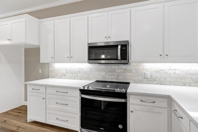 5128 Country Club Dr, Granbury, TX 76049 - kitchen featuring stainless steel appliances, white cabinetry, light countertops, backsplash, and wood finished floors