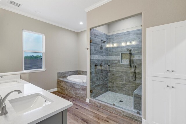 5128 Country Club Dr, Granbury, TX 76049 - bathroom with a garden tub, crown molding, wood finished floors, a stall shower, and double vanity