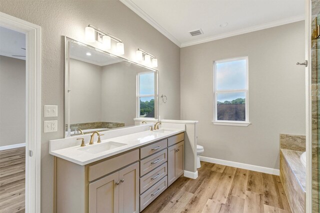 5128 Country Club Dr, Granbury, TX 76049 - full bathroom featuring wood finished floors, double vanity, tiled bath, ornamental molding, and baseboards