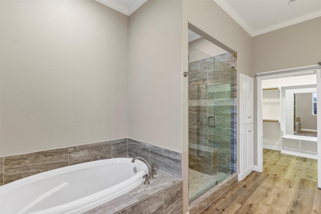 5128 Country Club Dr, Granbury, TX 76049 - bathroom featuring a garden tub, a stall shower, a walk in closet, crown molding, and wood finished floors